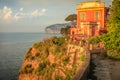 Sorrento cityscape above cliffs at golden sunset, Gulf of Naples, Southern Italy