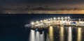 Night panorama of water pier at Meta di Sorrento full of lights with Naples in background Royalty Free Stock Photo