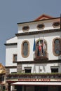 Sorrento, Italy - Jul 9, 2019: Facade of building with balcony and flags on basilica of St. Anthony Royalty Free Stock Photo