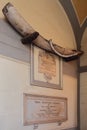 Sorrento, Italy - Jul 9, 2019: Whale rib trophy and commemorative plaques on stone wall on Basilica of St. Anthony