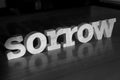 Sorrow, text words typography written with wooden letter on black background, life and business negativity