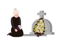 Sorrowful elderly woman dressed in mourning clothes crying near grave with headstone and wreath. Sad widow grieving on