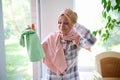 Sorrowful Arab Muslim woman in hijab, housewife holds her head from fatigue, closes her eyes from frustration and many household