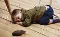 Sorrowful little boy on floor