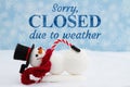Sorry closed due to weather with a snowman with snow