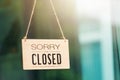 SORRY WE ARE CLOSED PLEASE COME BACK AGAIN notice sign wood board label hanging through glass door Royalty Free Stock Photo