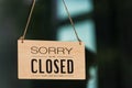 SORRY WE ARE CLOSED PLEASE COME BACK AGAIN notice sign wood board label hanging through glass door Royalty Free Stock Photo