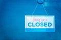 Sorry we are closed, sign board hanging on door of cafe.A business sign that says \'Sorry, We\'re Closed