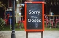 Sorry we are closed sign hanging outside a restaurant, store, office or other Royalty Free Stock Photo