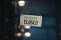 Sorry we are closed sign hanging outside a restaurant, store, office or other. Closed sign in a shop showroom with reflections bok Royalty Free Stock Photo