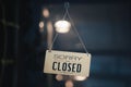 Sorry we are closed sign hanging outside a restaurant, store, office or other. Closed sign in a shop showroom with reflections bok Royalty Free Stock Photo