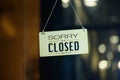 Sorry we are closed sign hanging outside a restaurant, store, office or other. Closed sign in a shop showroom with reflections bok Royalty Free Stock Photo