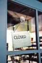 Sorry we are closed sign hanging on the window blue door shop Royalty Free Stock Photo