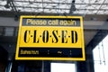 Sorry we are closed sign hanging on a window door outside a restaurant, store Royalty Free Stock Photo