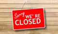 Sorry we are closed sign on wooden background Royalty Free Stock Photo