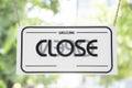 Sorry we are closed/Welcome we`re open ,sign label on the door store is closing earlier for social distancing