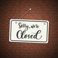 Sorry, we are closed. White sign with shadow isolated on red brick background Royalty Free Stock Photo