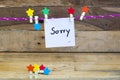 sorry message card handwriting with colorful wooden star clips hang pink rope