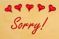 Sorry message with red glass hearts