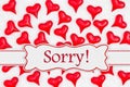 Sorry message with red hearts on white fabric Royalty Free Stock Photo