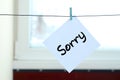 Sorry. Note is written on a white sticker that hangs with a clot Royalty Free Stock Photo