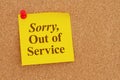 Sorry out of Service message on yellow sticky note on a corkboard Royalty Free Stock Photo