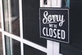 Sorry we\'re closed sign. grunge image hanging on cafe glass door Royalty Free Stock Photo