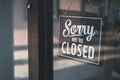 Sorry we\'re closed sign. grunge image hanging on cafe glass door. Royalty Free Stock Photo