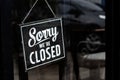 Sorry we\'re closed sign. grunge image hanging on a dirty glass door Royalty Free Stock Photo