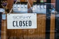Sorry we\'re closed sign. grunge image hanging on a dirty glass door Royalty Free Stock Photo