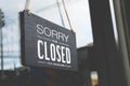 Sorry we\'re closed sign. grunge image hanging on a dirty glass door Royalty Free Stock Photo