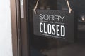 Sorry we're closed sign. grunge image hanging on a dirty glass door Royalty Free Stock Photo