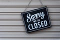 Sorry we\'re closed sign. grunge image hanging on a metal door. Royalty Free Stock Photo