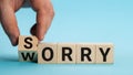 Sorry to worry. Hand turns a cube and changes the word worry to sorry. Business concept, copy space Royalty Free Stock Photo