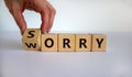 Sorry to worry. Hand turns a cube and changes the word `worry` to `sorry`. Beautiful white background. Business concept, copy Royalty Free Stock Photo