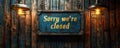 Sorry were closed sign hanging on a dark wooden background indicating business hours, closure, and retail shop customer Royalty Free Stock Photo