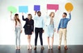 Sorry what did you say. Shot of a group of work colleagues standing next to each other while holding speech bubbles