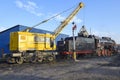 Railway crane loads coal into a Soviet L-series freight steam locomotive