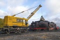 Railway crane KZh-462 `Pervomaets` loads coal old Soviet steam locomotive