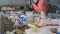 Sorting of garbage on the conveyor of the waste recycling plant, Russia