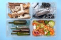 Sorting garbage. Four transparent containers with trash on a blue background: glass, plastic, organic trash, paper