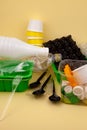 Sorting garbage. Plastic waste for recycling. Plastic bottles, containers, forks, spoons, egg packaging, caps. Yellow background