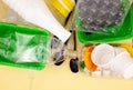 Sorting garbage. Plastic waste for recycling. Plastic bottles, containers, forks, spoons, egg packaging, caps. Yellow background