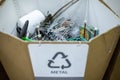 Sorting recyclables. The sorted scrap metal, is placed in a container with the appropriate marking Royalty Free Stock Photo