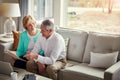 Sorting their household finances together. a mature couple going over their finances at home. Royalty Free Stock Photo