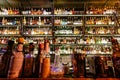 Sorts of liquors, whiskey, rum, tequila bottles inside big bar with shelves of drinks Royalty Free Stock Photo