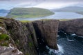 Sorvagsvatn or Leitisvatn, the biggest lake in the Faroe Islands on Vagar Island. Lake on a cliff high above the sea on a cloudy Royalty Free Stock Photo