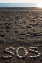 SOS message made with stones on the beach Royalty Free Stock Photo