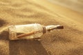 SOS message in glass bottle on sand Royalty Free Stock Photo