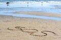 SOS message written on sand near sea Royalty Free Stock Photo